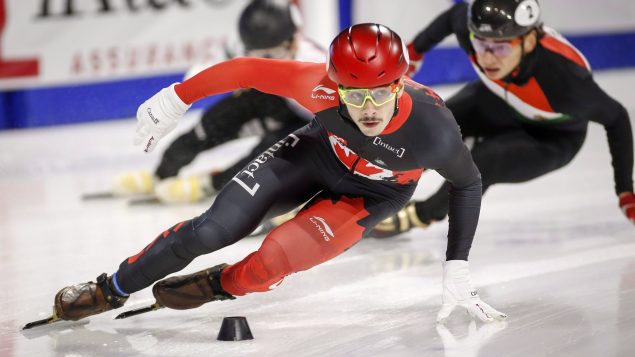 Le patineur de vitesse de courte piste Samuel Girard lors d'un virage dans une épreuve de 500 mètres.