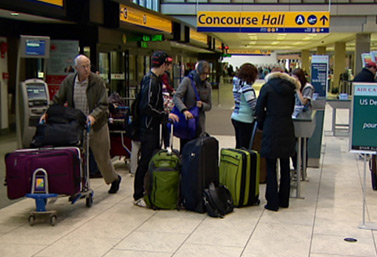 It`s a busy day for several passengers at the Calgary International Airport, Alberta. (Canadian Broadcasting Corporation) 