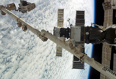 On August 13, 2007, Canadian astronaut Dave Williams is secured to the Canadarm while doing maintenance work at the International Space Station. (NASA/Associated Press)