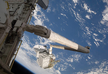 In this photo from July 21, 2009, the space shuttle Endeavour deploys the second-generation Canadarm. (Canadian Press/NASA)