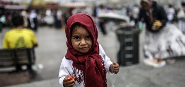 Une jeune réfugiée syrienne mange des restes que sa mère a trouvé dans une poubelle, à Istanbul. © Getty Images/AFP/Bulent Kilic