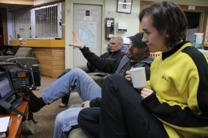 RCI journalist Eilis Quinn, cameraman Luc Robida and soundman Jean Cayouette review the day's work on a video monitor at their hotel in Clyde River, Nunavut