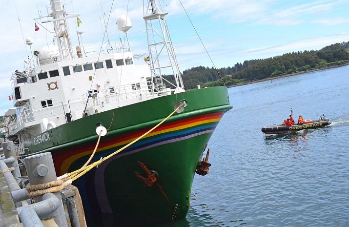 A skiff runs alongside the Greenpeace vessel Esperanza on Wednesday, June 27, 2012 at Kodiak City Pier 2. (James Brooks / Kodiak Daily Mirror / AP)