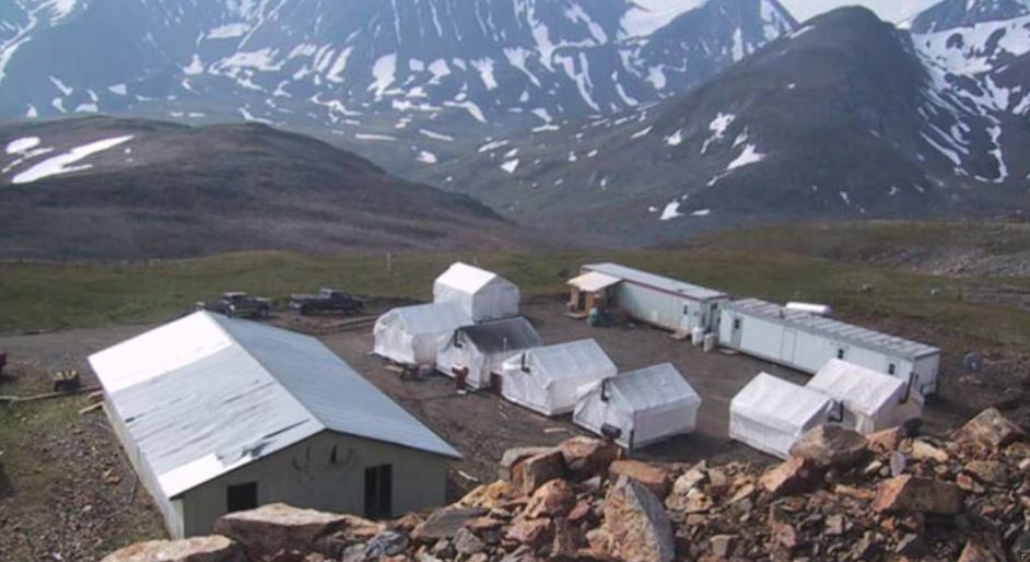 Quelques tentes et des roulottes au milieu des montagnes au camp de la mine Mactung.