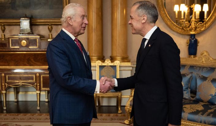 Le roi Charles III serre la main du premier ministre canadien, Mark Carney.