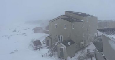 Une vue depuis un balcon de maisons enneigées à Iqaluit durant un blizzard, le 15 mai 2025.