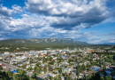 Une vue en hauteur de la ville de Whitehorse mélangeant arbres et bâtiments.